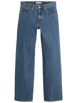Jean 5 poches en coton bleu délavé avec une coupe large et jacron beige