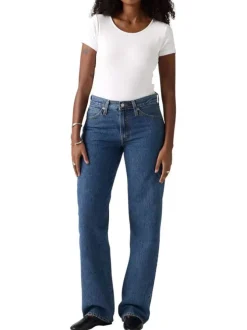Jean 5 poches en coton bleu délavé avec une coupe large et jacron beige