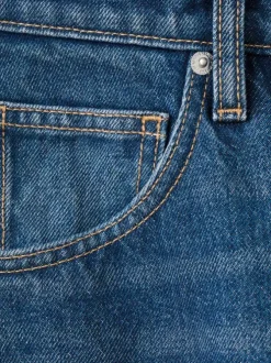 Jean taille haute en coton indigo délavé avec une coupe bootcut