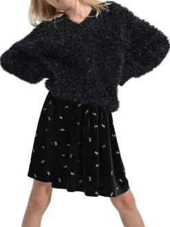 Jupe courte noire unie en velours avec une coupe plissée et nœuds brodés