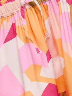 Jupe courte pêche à imprimé camouflage pastel avec volants et taille élastiquée