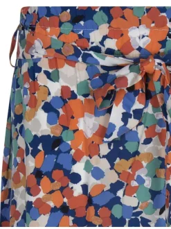 Jupe courte bleue fleurie avec une coupe paper bag et ceinture à nouer