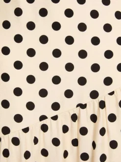 Jupe longue beige à motifs pourvu d'une coupe évasée et d'une taille haute