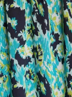 Jupe longue turquoise imprimée mouchetée avec une coupe droite fluide