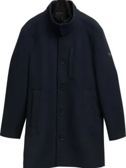 Manteau marine uni avec un col montant et boutonnière à l'avant