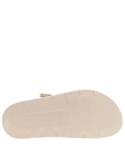 Mules écrues à semelle plate et un logo en relief sur le talon