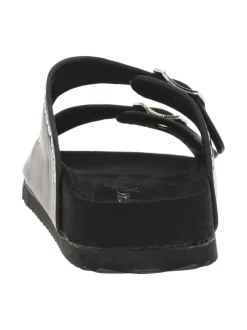 Mules noires à œillets métalliques et à boucles à ardillon sur le côté
