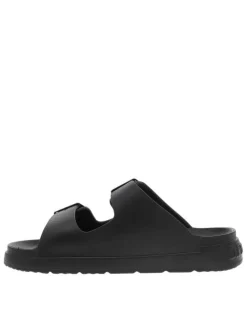 Mules noires à semelle plate et une fermeture à boucle à ardillon