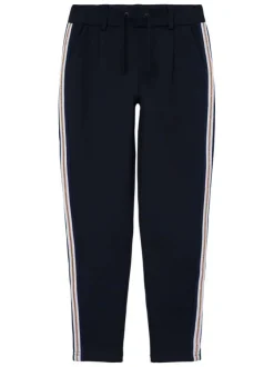 Pantalon marine style jogging avec une coupe slim et liseré en lurex doré