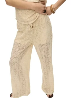 Pantalon beige en guipure coupe ample pourvu d'une taille élastiquée