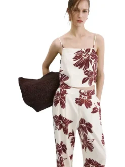 Pantalon beige à motifs pourvu d'une coupe large et de détails plissés