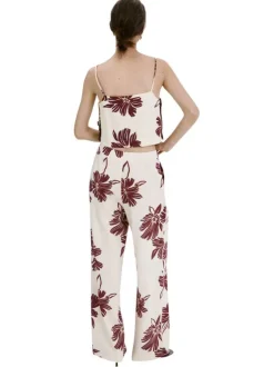 Pantalon beige à motifs pourvu d'une coupe large et de détails plissés