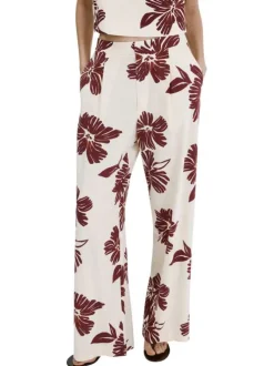 Pantalon beige à motifs pourvu d'une coupe large et de détails plissés