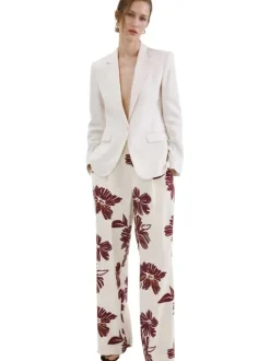 Pantalon beige à motifs pourvu d'une coupe large et de détails plissés