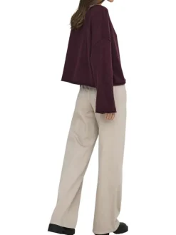Pantalon beige uni avec une coupe flare avec un zip et un bouton