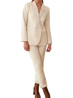 Pantalon beige uni avec une coupe slim et logo de la marque en bijou argenté