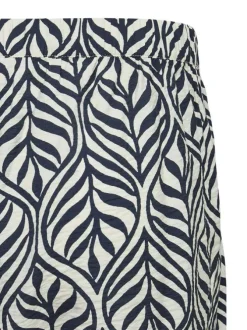 Pantalon blanc et bleu marine à motif tropical avec une coupe bootcut