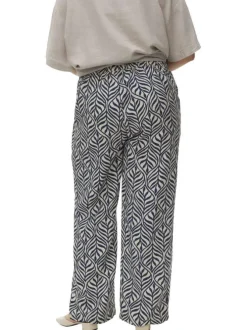 Pantalon blanc et bleu marine à motif tropical avec une coupe bootcut