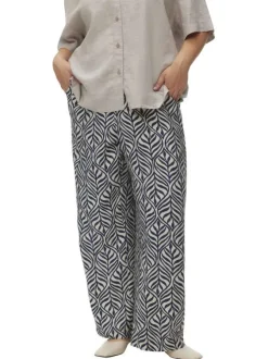 Pantalon blanc et bleu marine à motif tropical avec une coupe bootcut