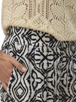 Pantalon Chino beige à taille élastiquée pourvu d'un motif abstrait