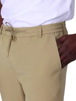 Pantalon chino beige uni avec une coupe ajustée à zip et à bouton