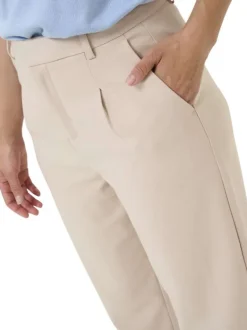 Pantalon chino beige uni taille haute pourvu d'une coupe ajustée