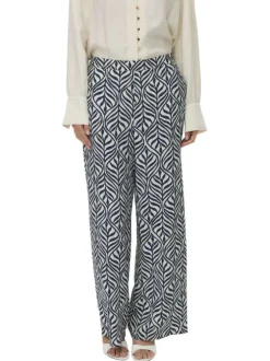Pantalon chino bleu et blanc coupe ample orné d'un motif végétal