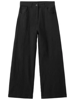 Pantalon chino en coton noir uni avec une coupe bootcut et des poches raglan