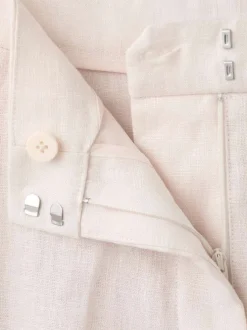 Pantalon chino en lin beige uni pourvu d'une taille intermédiaire