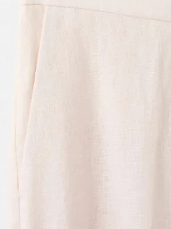 Pantalon chino en lin beige uni pourvu d'une taille intermédiaire