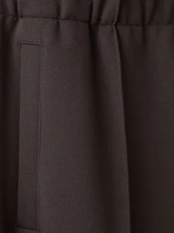 Pantalon chino marron uni pourvu d'une coupe bootcut et d'une taille élastiquée