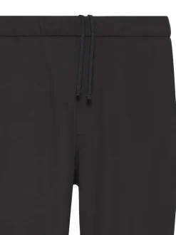 Pantalon chino noir uni pourvu d'une coupe slim et d'une taille elastiquée