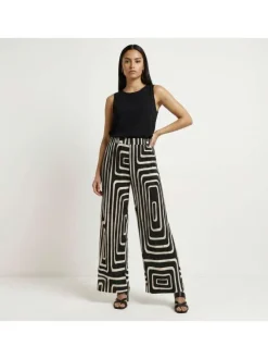 Pantalon écru et noir plissé pourvu d'un motif géométrique et d'une coupe ample