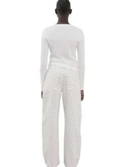 Pantalon en coton blanc à pois pourvu de passants pour la ceinture