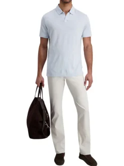 Pantalon en coton écru uni avec une coupe ajustée et des poches à l'italienne