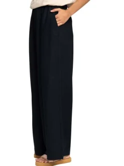Pantalon noir à coupe ample pourvu de poches plaquées sur les côtés