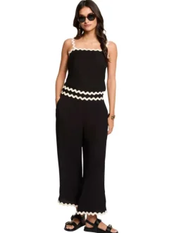 Pantalon noir uni pourvu de finitions festonnées contrastées