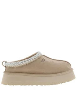 Pantoufles Tazz en cuir beige avec une semelle à plateforme et logo embossé