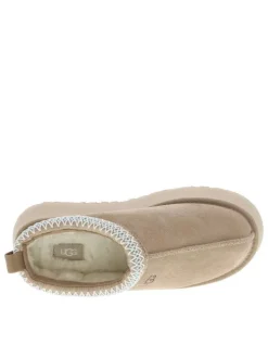 Pantoufles Tazz en cuir beige avec une semelle à plateforme et logo embossé