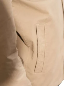 Parka en coton beige unie avec une coupe droite et un col montant