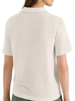 Polo beige uni pourvu de manches courtes et d'un col v à revers