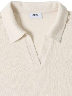 Polo beige uni pourvu de manches courtes et d'un col v à revers