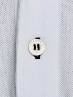 Polo blanc uni en coton avec une coupe droite avec liseré noir sur le col et les manches