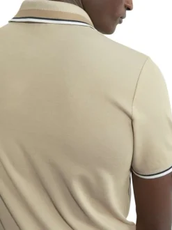 Polo en coton beige en maille piquée à coupe droite avec un col à revers