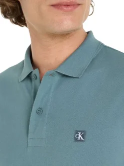 Polo en coton bleu avec une coupe droite un col boutonné et logo à la poitrine