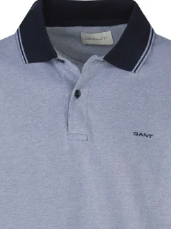 Polo en coton bleu uni piqué avec une coupe droite et un col à revers