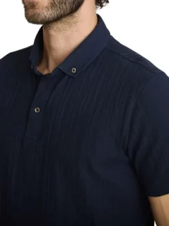 Polo en coton marine à coupe droite pourvu d'un col à revers boutonné