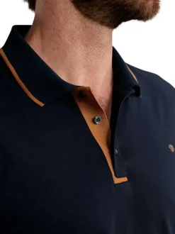 Polo en coton marine uni pourvu de manches courtes et d'un col boutonné