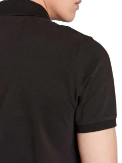 Polo en coton noir avec une fermeture boutonnée et logo iconique