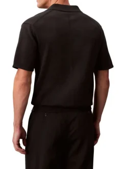 Polo en coton noir à coupe droite pourvu d'un col à revers boutonné